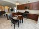 Modern kitchen with granite countertops, stainless steel appliances, and breakfast nook at 232 Carlino Dr, Nokomis, FL 34275