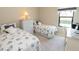 Bedroom with two twin beds, dresser, and workspace at 232 Carlino Dr, Nokomis, FL 34275