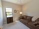 Bedroom with brown sofa and large window at 232 Carlino Dr, Nokomis, FL 34275