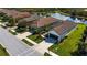 Single-story home with brown tile roof, two-car garage, and manicured lawn at 232 Carlino Dr, Nokomis, FL 34275