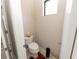 Small half bathroom with toilet and pedestal sink at 232 Carlino Dr, Nokomis, FL 34275
