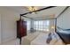Large bedroom with a four poster bed, water views and plantation shutters at 23787 Waverly Cir, Venice, FL 34293