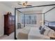 Large bedroom with a four poster bed, water views and plantation shutters at 23787 Waverly Cir, Venice, FL 34293