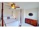 Bedroom with post bed, dresser, and window at 23787 Waverly Cir, Venice, FL 34293