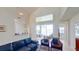 Bright living room with vaulted ceilings, leather furniture, and views of the pool and canal at 23787 Waverly Cir, Venice, FL 34293
