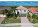 Two-story house with tile roof, green garage door, and well-manicured lawn at 23787 Waverly Cir, Venice, FL 34293