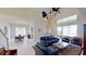 Spacious living room with high ceilings, leather furniture, and access to a lake view at 23787 Waverly Cir, Venice, FL 34293