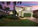 Two-story house with green garage door, landscaping, and a brick pathway at 23787 Waverly Cir, Venice, FL 34293