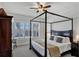 Large bedroom with a four poster bed, water views and plantation shutters at 23787 Waverly Cir, Venice, FL 34293