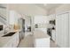 Spacious kitchen boasts white cabinets, stainless steel appliances, and an island at 23787 Waverly Cir, Venice, FL 34293