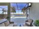 Enjoy lake views from this screened lanai with seating at 23787 Waverly Cir, Venice, FL 34293