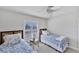 Twins bedroom with window, ceiling fan and blue bedding at 23787 Waverly Cir, Venice, FL 34293