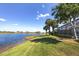 Expansive lakefront property with mature palm trees at 23787 Waverly Cir, Venice, FL 34293