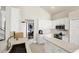 Bright kitchen with white cabinets, stainless steel appliances, and quartz countertops at 23787 Waverly Cir, Venice, FL 34293