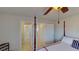 Bedroom with post bed and access to other rooms at 23787 Waverly Cir, Venice, FL 34293