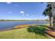 Scenic view of a tranquil lake with lush greenery at 23787 Waverly Cir, Venice, FL 34293