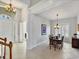 Bright dining room features a formal table with chandelier and hardwood floors at 23787 Waverly Cir, Venice, FL 34293