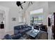 Living room with high ceilings, dark leather furniture, and water views at 23787 Waverly Cir, Venice, FL 34293
