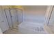 Bathroom with a soaking tub and walk-in shower at 23787 Waverly Cir, Venice, FL 34293