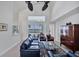 Living room with high ceilings, dark leather furniture, and water views at 23787 Waverly Cir, Venice, FL 34293