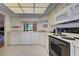 Well-equipped kitchen with white cabinets and black appliances at 201 Woodland Dr # 201, Osprey, FL 34229