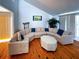 Relaxing living room with a large sectional sofa and wood floors at 201 Woodland Dr # 201, Osprey, FL 34229