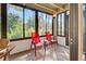 Sunroom with red chairs and view of lush greenery at 201 Woodland Dr # 201, Osprey, FL 34229