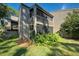 Private backyard with lush tropical landscaping and a fence at 201 Woodland Dr # 201, Osprey, FL 34229