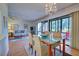 Open dining area with glass table and chairs, tiled floor, and access to patio at 201 Woodland Dr # 201, Osprey, FL 34229