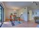 Bright dining room with tiled floor, glass table, and access to the lanai at 201 Woodland Dr # 201, Osprey, FL 34229