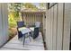 Small patio with wicker chairs and glass table at 201 Woodland Dr # 201, Osprey, FL 34229