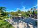Community patio area with tables and pond view at 201 Woodland Dr # 201, Osprey, FL 34229
