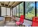 Bright sunroom with wicker furniture and view of the garden at 201 Woodland Dr # 201, Osprey, FL 34229