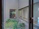 Private courtyard with lush greenery and patio furniture at 201 Woodland Dr # 201, Osprey, FL 34229