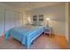Bedroom with striped bedding and white shutters at 201 Woodland Dr # 201, Osprey, FL 34229