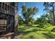 Landscaped backyard with tropical plants and a screened porch at 201 Woodland Dr # 201, Osprey, FL 34229