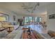 Open living room and dining area with tiled floors and access to a lanai at 201 Woodland Dr # 201, Osprey, FL 34229