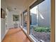 Light-filled hallway with terracotta tile floor and access to a private courtyard at 201 Woodland Dr # 201, Osprey, FL 34229