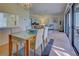 Bright dining area with glass table and seating for four, open to living room at 201 Woodland Dr # 201, Osprey, FL 34229