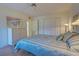 Bright bedroom with striped bedding and white shutters at 201 Woodland Dr # 201, Osprey, FL 34229