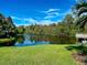 Serene pond view with lush landscaping at 201 Woodland Dr # 201, Osprey, FL 34229