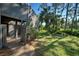 Spacious backyard with lush greenery and mature trees at 201 Woodland Dr # 201, Osprey, FL 34229
