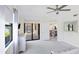 Bright bedroom with access to a screened-in patio and view of a lake at 10780 Tarflower Dr # 102, Venice, FL 34293