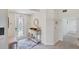 Bright and airy entryway with decorative console table and mirror at 10780 Tarflower Dr # 102, Venice, FL 34293