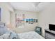 Guest bedroom with a queen-size bed and coastal decor at 10780 Tarflower Dr # 102, Venice, FL 34293