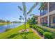 Landscaped backyard with lake view and lush greenery at 10780 Tarflower Dr # 102, Venice, FL 34293