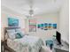 Guest bedroom with a queen-size bed and coastal decor at 10780 Tarflower Dr # 102, Venice, FL 34293