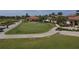 Aerial view of a golf course with golfers and golf carts at 10780 Tarflower Dr # 102, Venice, FL 34293