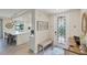 Bright entryway with bench, decorative mirror, and view into kitchen at 10780 Tarflower Dr # 102, Venice, FL 34293