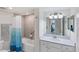 Bathroom with shower/tub combo, vanity with white cabinets, and blue shower curtain at 10780 Tarflower Dr # 102, Venice, FL 34293